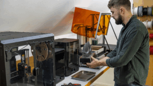 James removing a part from one of our Formlabs Form 4 SLA 3D printers