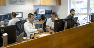 Photograph of the Marble office with people working at computers or in discussion